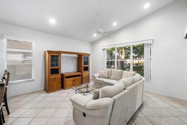 living room with ceiling fan, lofted ceiling, and light tile patterned flooring