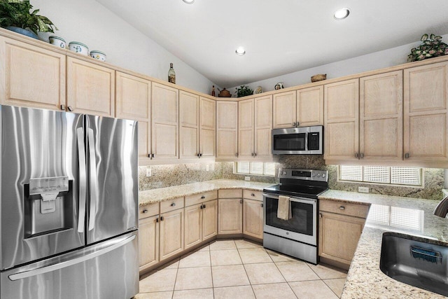 kitchen with decorative backsplash, light brown cabinetry, stainless steel appliances, sink, and light tile patterned flooring