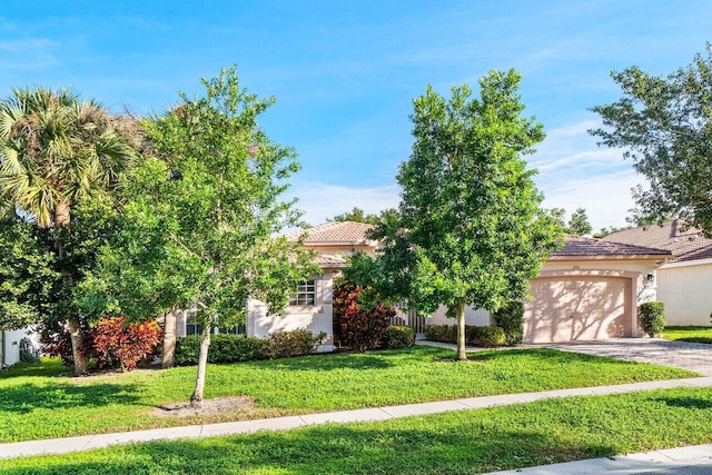 view of property hidden behind natural elements featuring a front yard and a garage