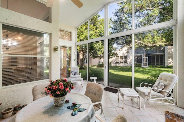 sunroom / solarium featuring a wealth of natural light, ceiling fan, and lofted ceiling