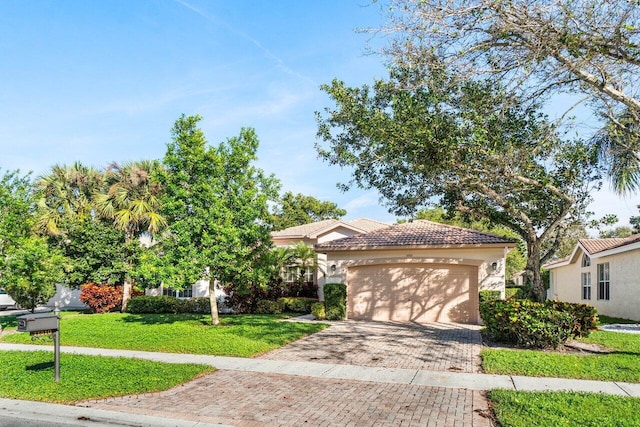 view of front facade with a garage and a front lawn