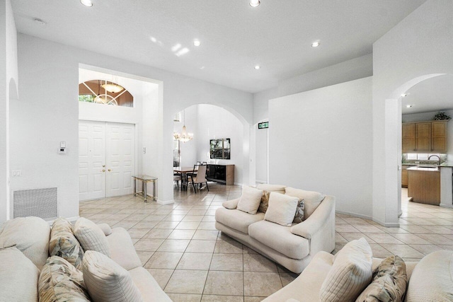 living room with light tile patterned floors and a towering ceiling