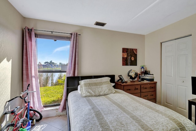 tiled bedroom featuring a closet