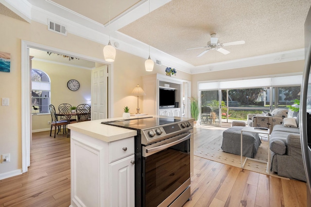 kitchen with light wood-style floors, stainless steel electric range oven, white cabinetry, and open floor plan