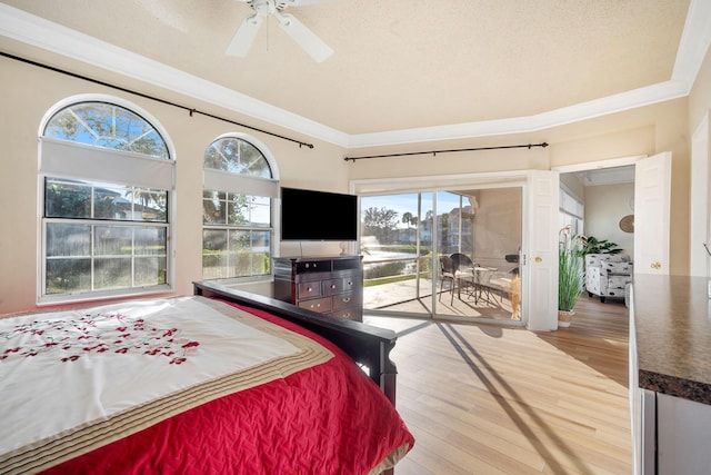 bedroom with access to outside, crown molding, wood finished floors, and multiple windows