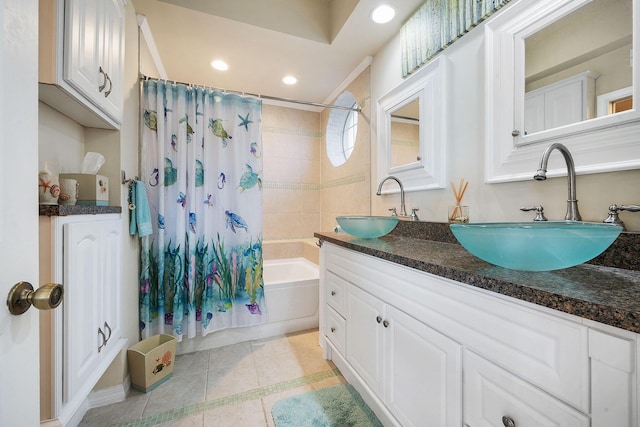 full bath with double vanity, shower / bath combo, a sink, and tile patterned flooring