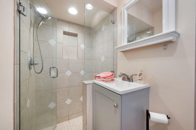 bathroom featuring a shower stall and vanity