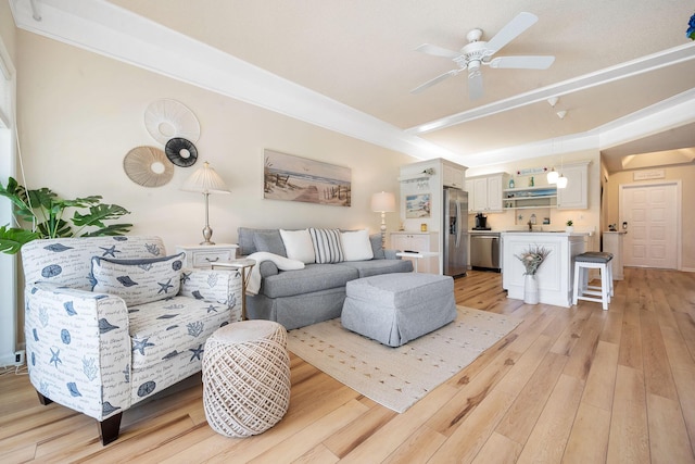 living area featuring ceiling fan and light wood finished floors