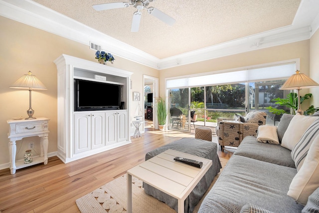 living room with visible vents, ceiling fan, ornamental molding, a textured ceiling, and light wood-type flooring