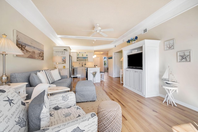 living room with a ceiling fan, light wood-type flooring, visible vents, and baseboards