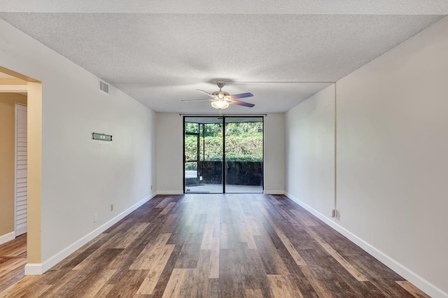 spare room with floor to ceiling windows, ceiling fan, dark wood-type flooring, and a textured ceiling