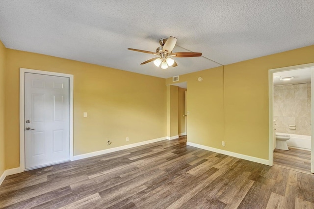 spare room featuring ceiling fan, wood-type flooring, and a textured ceiling