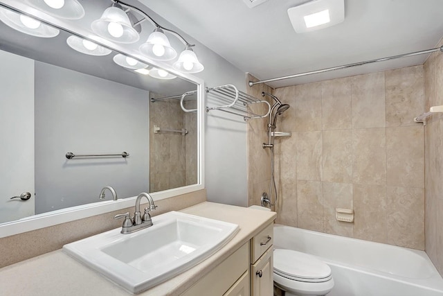 full bathroom with vanity, toilet, and tiled shower / bath