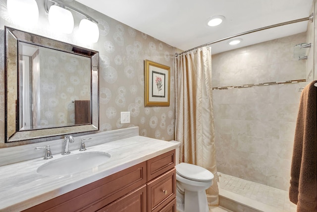 bathroom featuring curtained shower, vanity, and toilet