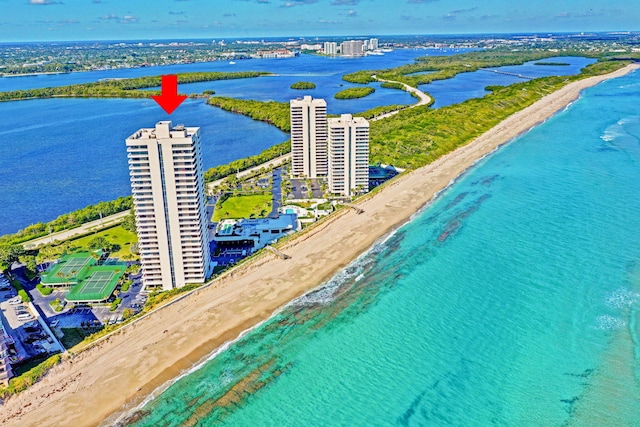 bird's eye view with a water view and a beach view