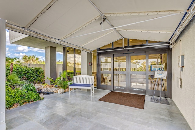 unfurnished sunroom with lofted ceiling