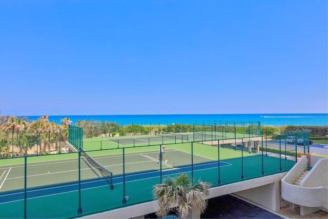 view of sport court with a water view