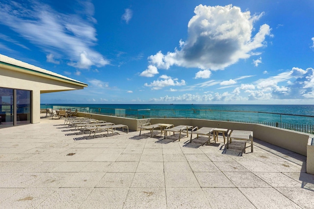 view of patio / terrace featuring a water view and a view of the beach