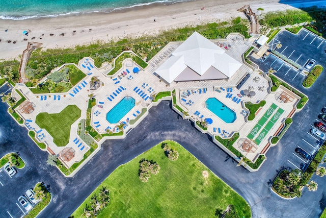 drone / aerial view featuring a water view and a beach view