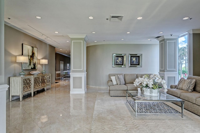 living room with ornate columns and crown molding