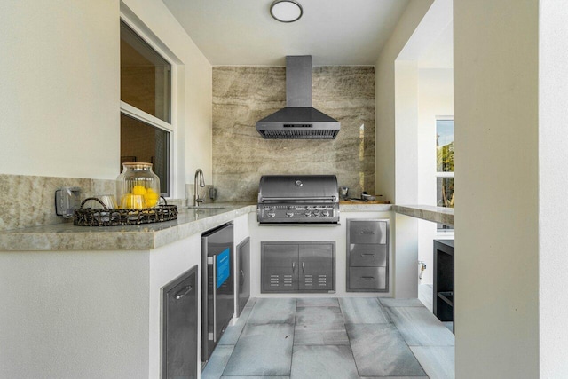 view of patio / terrace featuring a grill, sink, and an outdoor kitchen