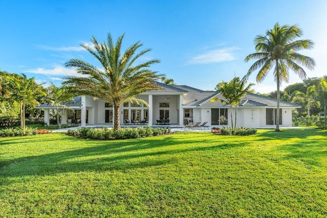 rear view of house featuring a lawn, a patio, and ceiling fan