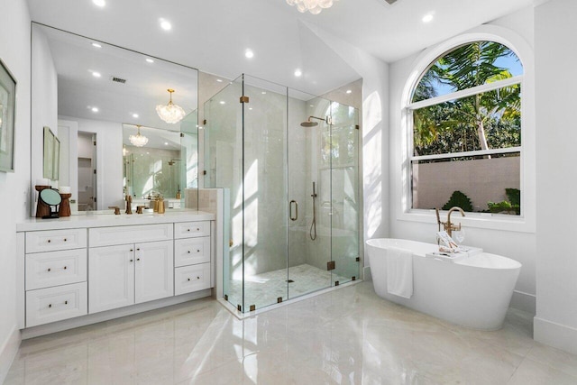 bathroom with vanity and independent shower and bath