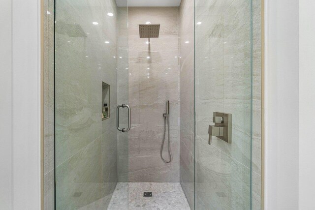 bathroom with a shower with shower door