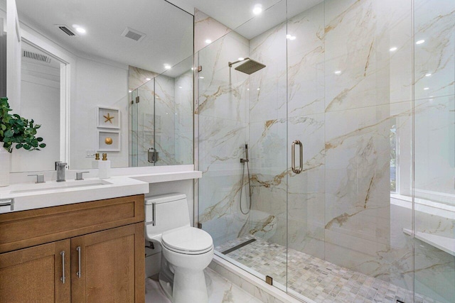 bathroom featuring vanity, toilet, and an enclosed shower