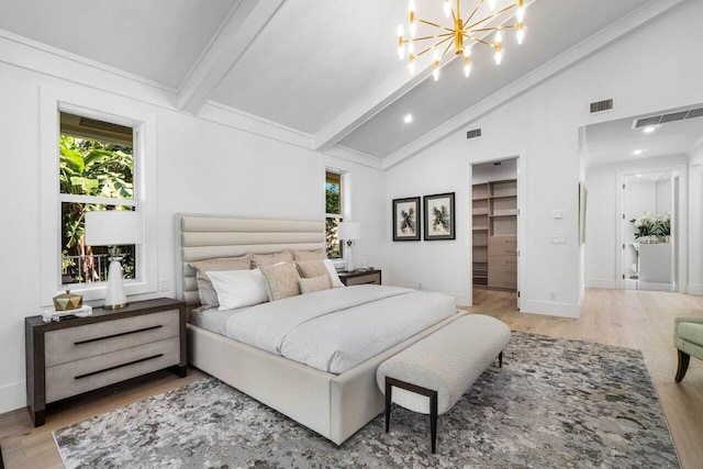 bedroom featuring a spacious closet, high vaulted ceiling, light hardwood / wood-style flooring, a notable chandelier, and beam ceiling