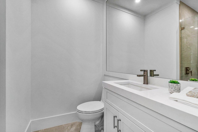 bathroom with an enclosed shower, vanity, and toilet