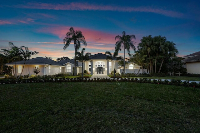 ranch-style house with a yard