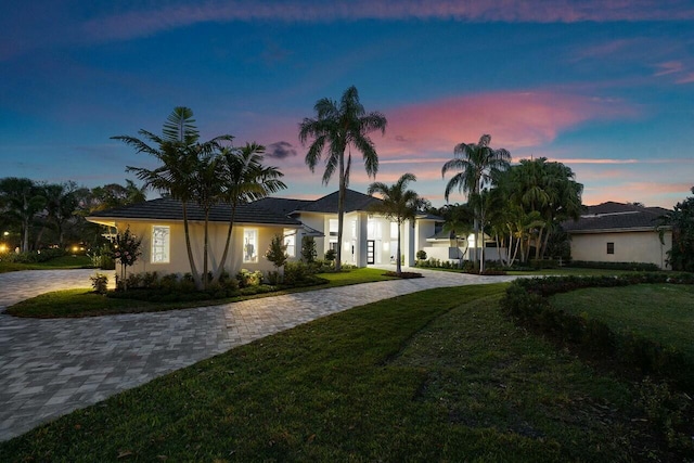 ranch-style home with a lawn