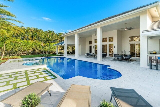 back of house with ceiling fan and a patio