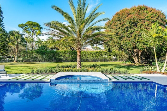 view of pool featuring an in ground hot tub and a lawn