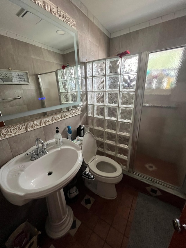 bathroom with tile walls, walk in shower, backsplash, and toilet