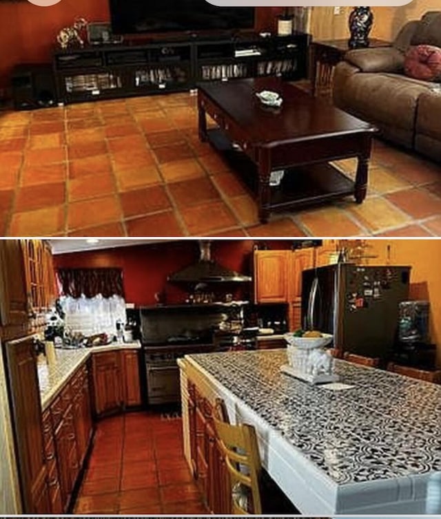 kitchen with black fridge, tile patterned flooring, extractor fan, and gas range