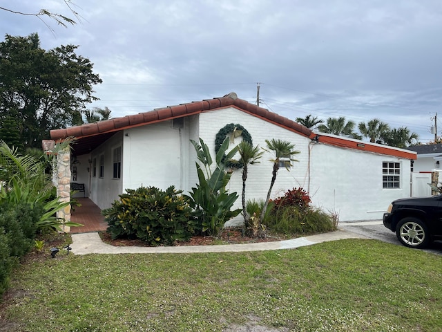 view of property exterior with a yard