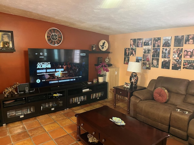 living room with a textured ceiling and tile patterned flooring