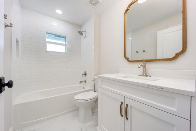 full bathroom featuring vanity, tiled shower / bath combo, and toilet