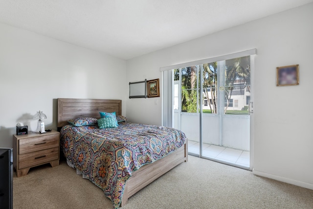 bedroom featuring access to exterior, baseboards, and carpet floors