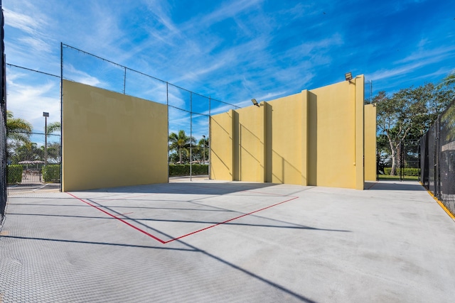 view of sport court featuring community basketball court, fence, and a wealth of natural light