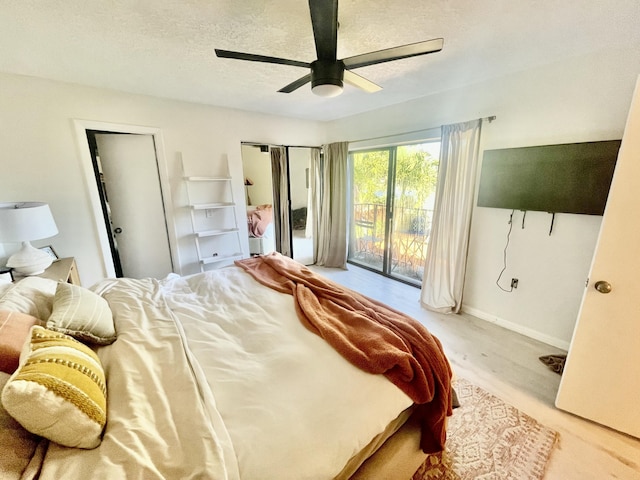 bedroom featuring access to exterior, baseboards, a ceiling fan, and a textured ceiling