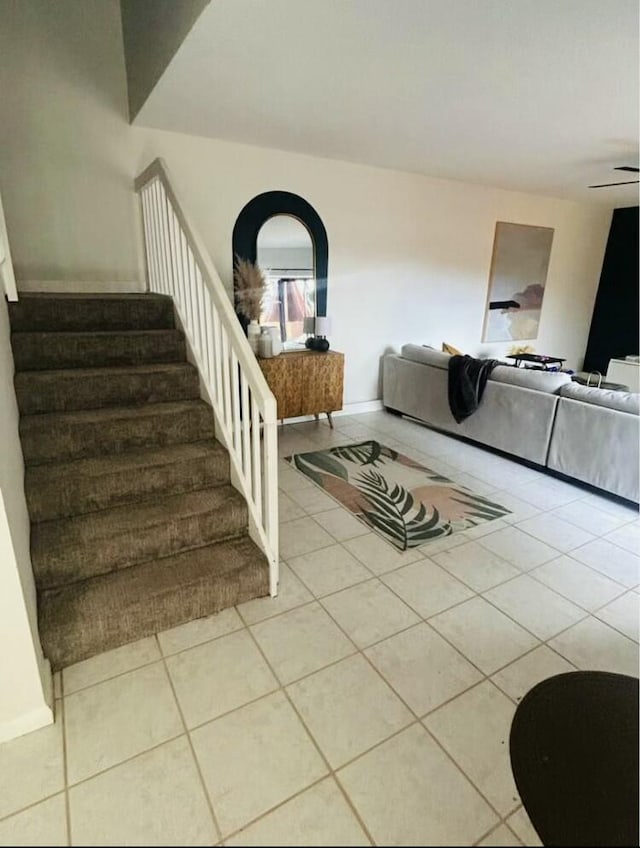 interior space with light tile patterned floors and ceiling fan