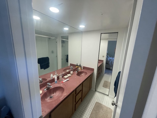 full bathroom featuring ensuite bath, a stall shower, a sink, and tile patterned floors