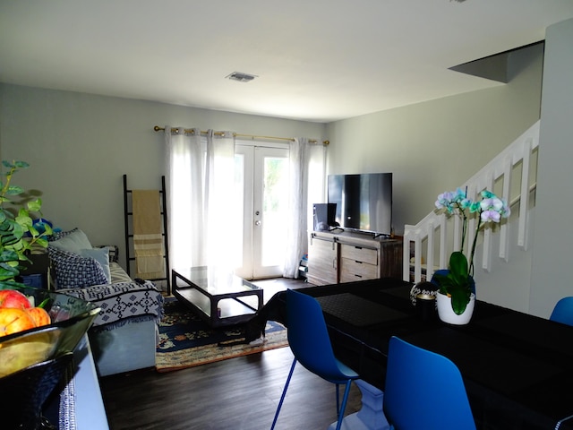 living room featuring french doors and dark wood-type flooring