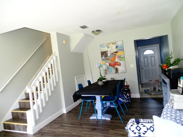 dining space with dark wood-type flooring