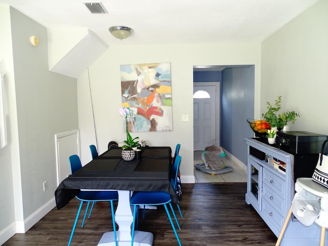 dining room with dark hardwood / wood-style flooring