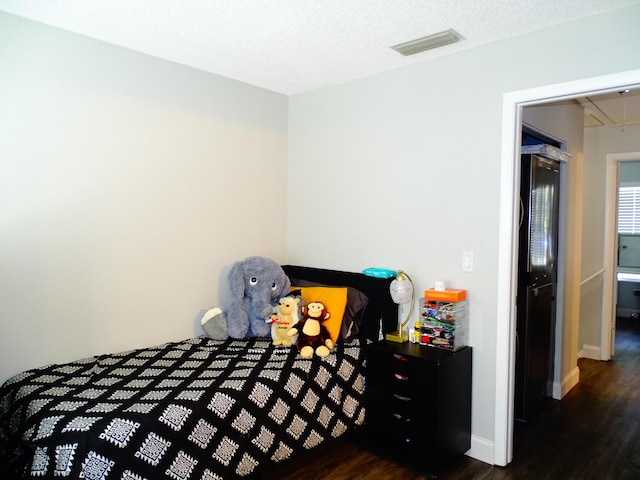 bedroom featuring dark hardwood / wood-style flooring