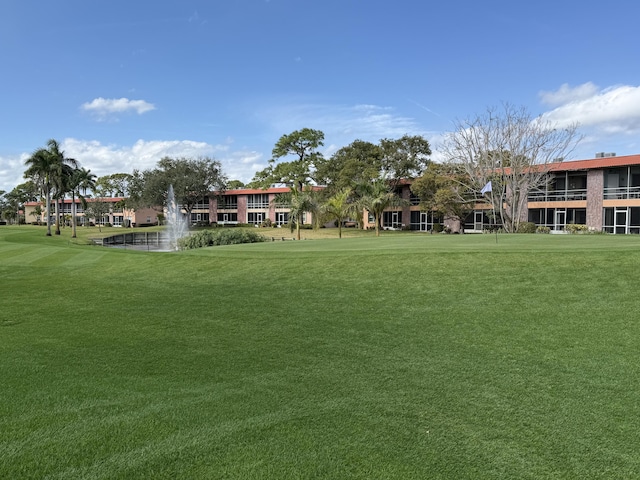 view of home's community with a yard